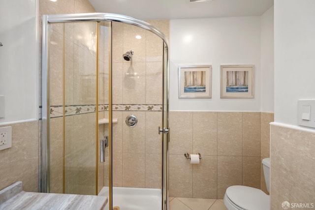 1871 Alemany Blvd, San Francisco, CA 94112 - bathroom featuring tile walls, toilet, a stall shower, wainscoting, and tile patterned flooring