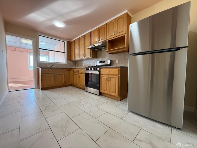 kitchen featuring appliances with stainless steel finishes and decorative backsplash