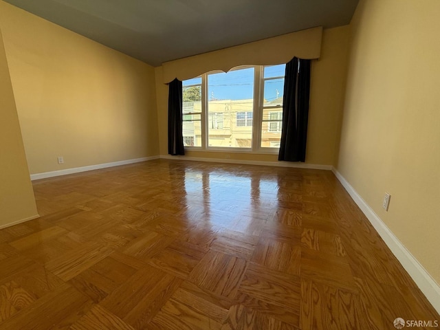 unfurnished room with light parquet flooring