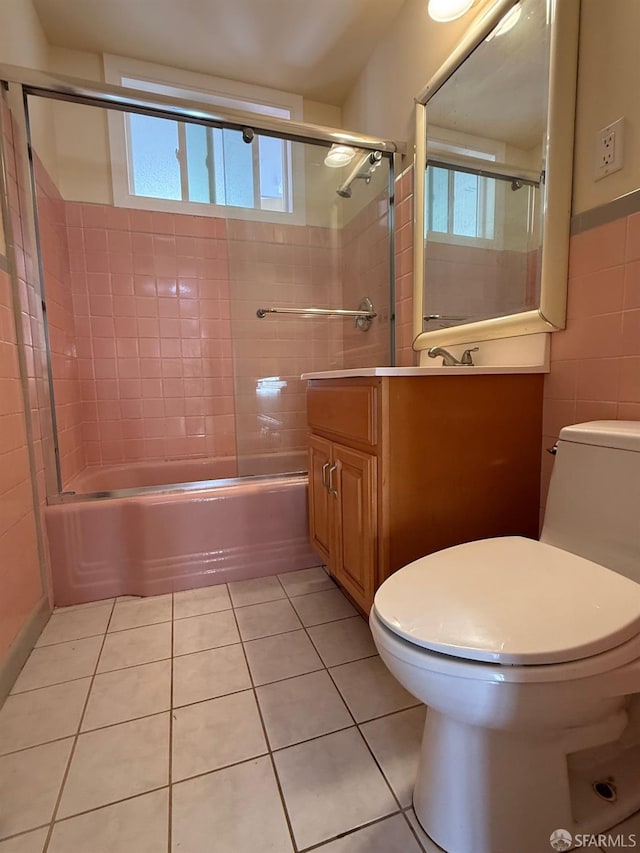 full bathroom featuring enclosed tub / shower combo, vanity, toilet, and tile patterned flooring