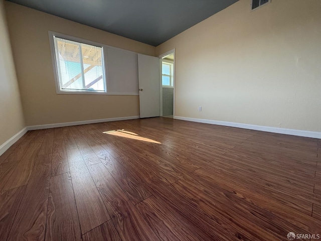 spare room with dark hardwood / wood-style floors