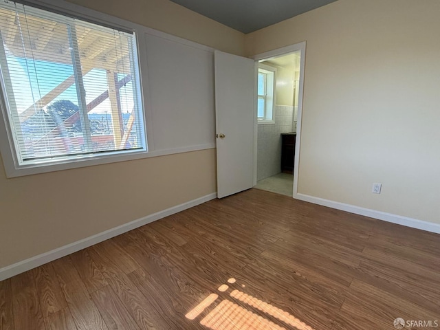 unfurnished room with hardwood / wood-style flooring