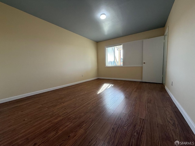 empty room with dark hardwood / wood-style floors