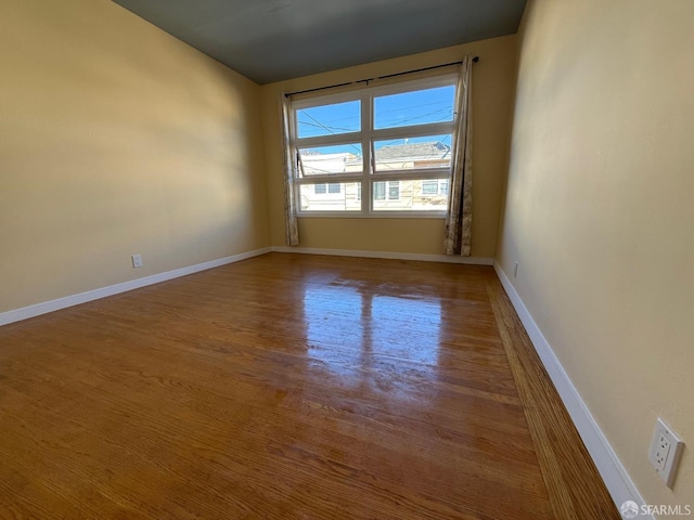 empty room with hardwood / wood-style flooring