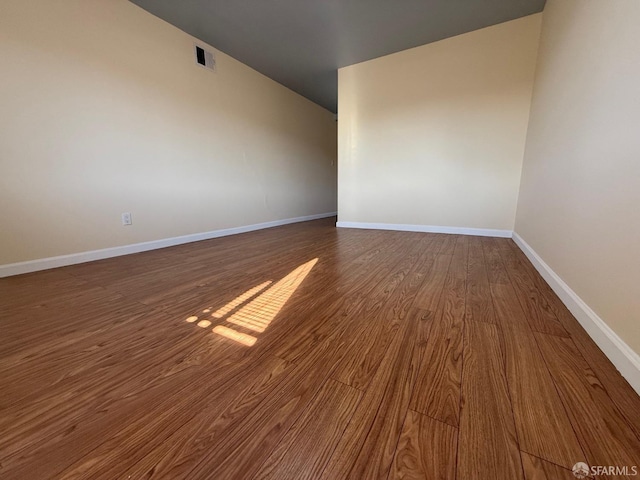 unfurnished room with dark hardwood / wood-style floors