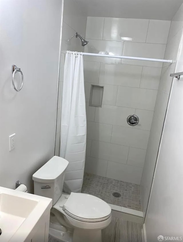 full bath featuring toilet and a stall shower