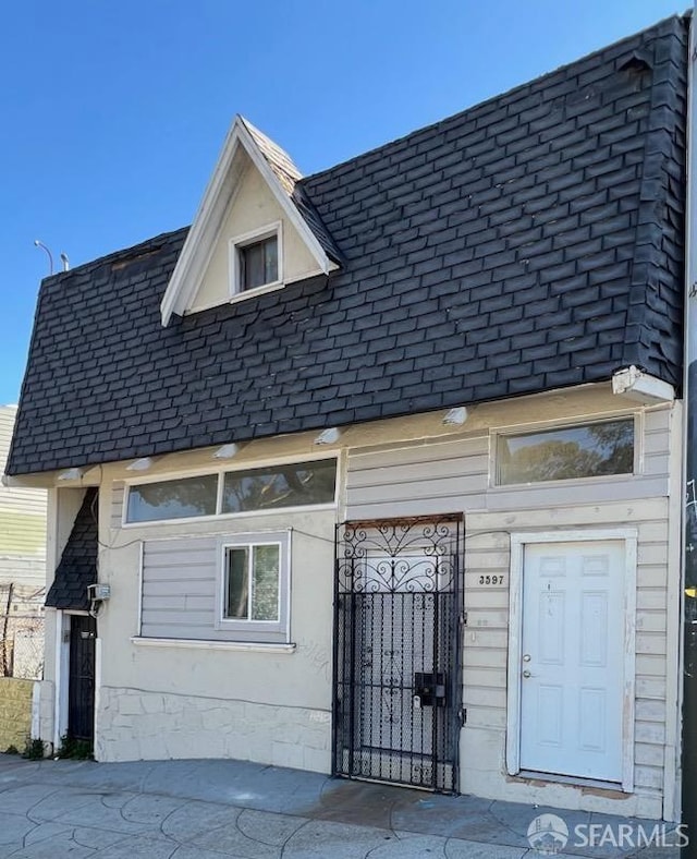 exterior space with roof with shingles