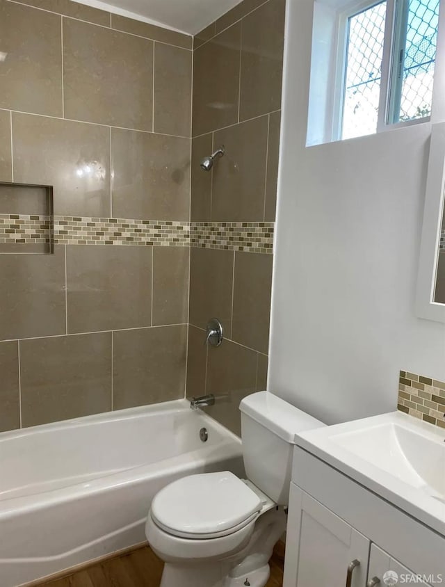 bathroom with shower / washtub combination, toilet, vanity, and wood finished floors