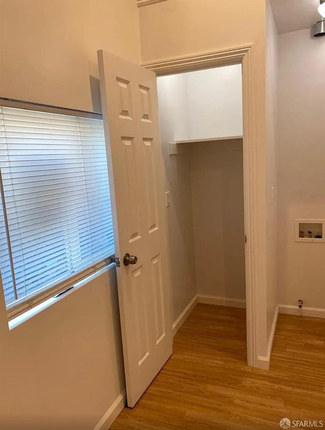 interior space featuring baseboards and wood finished floors