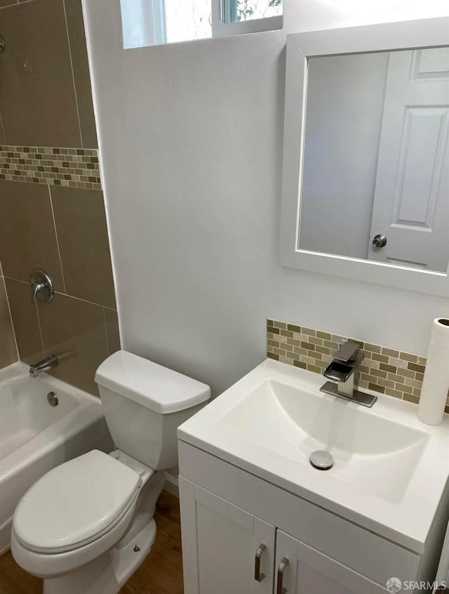 full bathroom featuring vanity, toilet, backsplash, and shower / bath combination