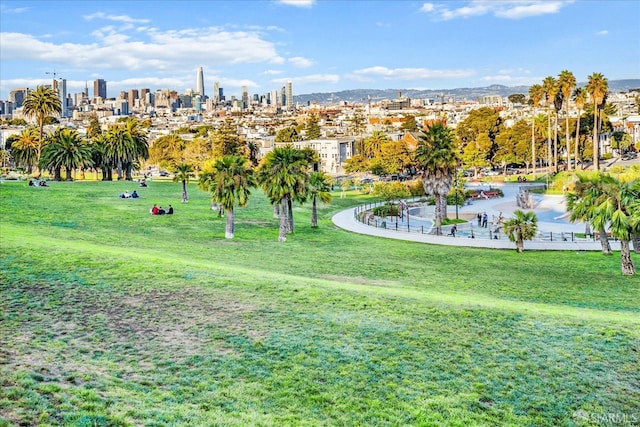 surrounding community featuring a view of city and a yard