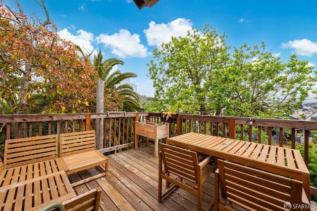 wooden terrace featuring outdoor dining space