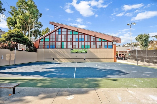 view of basketball court with fence and basketball court