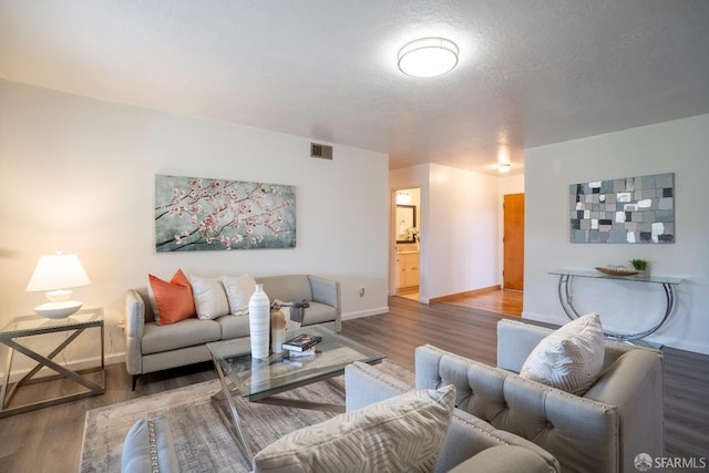 living room featuring hardwood / wood-style flooring and a textured ceiling