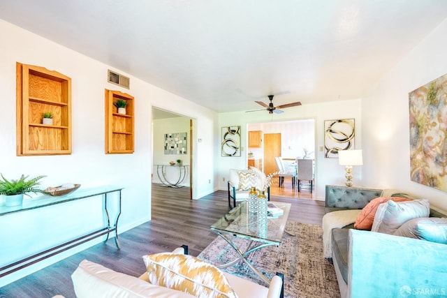 living room with dark hardwood / wood-style floors and ceiling fan