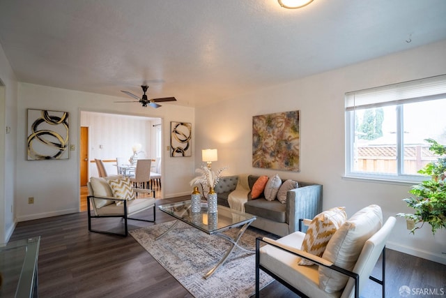 living room with dark hardwood / wood-style floors and ceiling fan