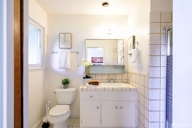 bathroom featuring tile patterned flooring, vanity, an enclosed shower, and toilet