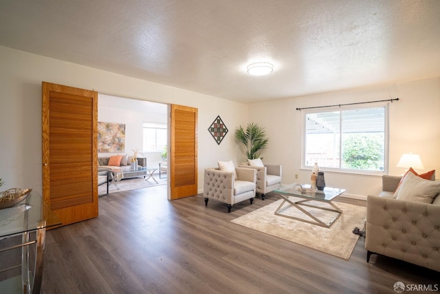 living room featuring dark hardwood / wood-style floors and a textured ceiling