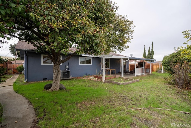 rear view of property featuring a yard