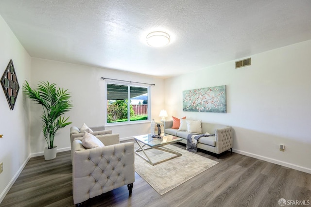 living room featuring hardwood / wood-style floors and a textured ceiling