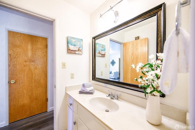 bathroom with vanity and hardwood / wood-style floors