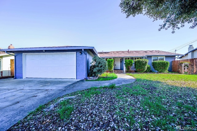 ranch-style house with a garage and a front lawn