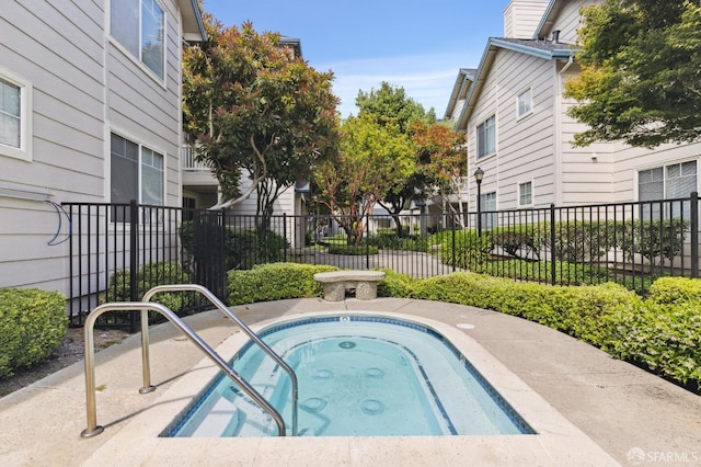 view of swimming pool featuring an in ground hot tub