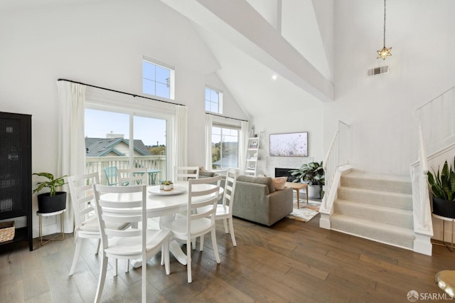 dining room featuring dark hardwood / wood-style flooring and high vaulted ceiling