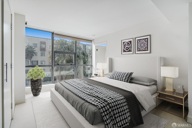 carpeted bedroom featuring floor to ceiling windows