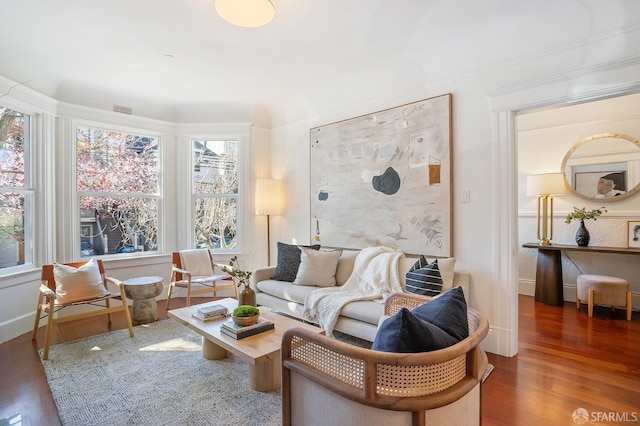 living room with baseboards and wood finished floors