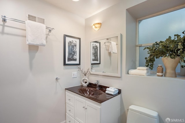 bathroom featuring vanity and toilet