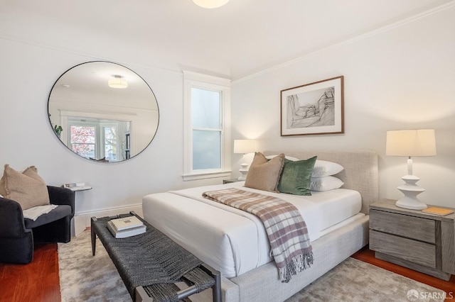 bedroom featuring crown molding and wood finished floors