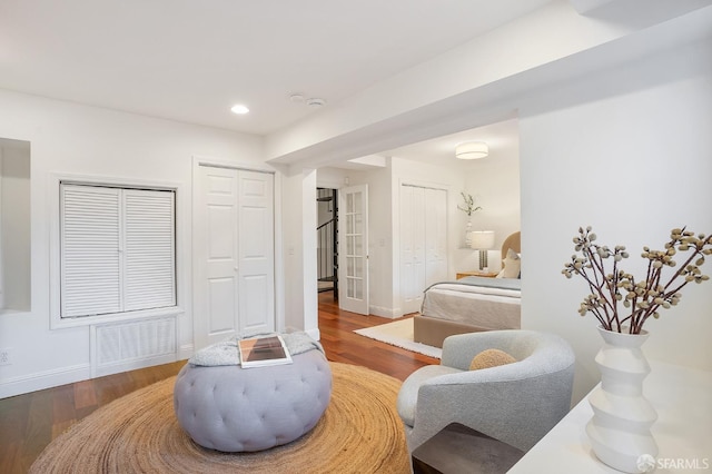 sitting room featuring baseboards, wood finished floors, visible vents, and recessed lighting