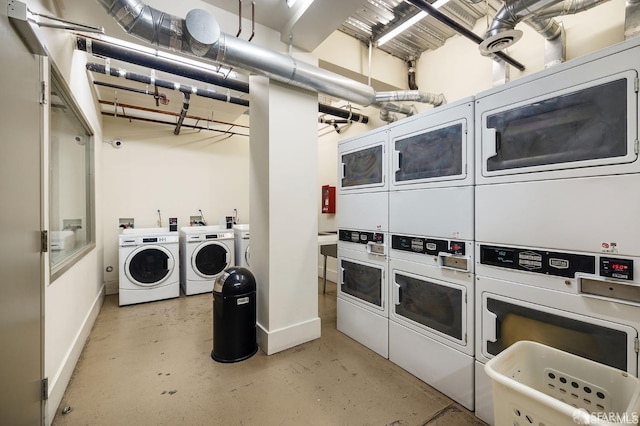 laundry area with stacked washer and clothes dryer and washing machine and clothes dryer