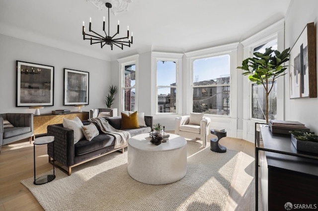 living room with a chandelier, hardwood / wood-style flooring, and a healthy amount of sunlight