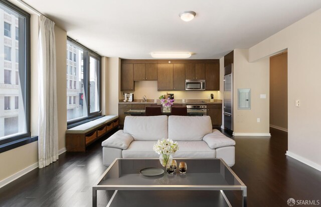 living room with dark hardwood / wood-style flooring and sink