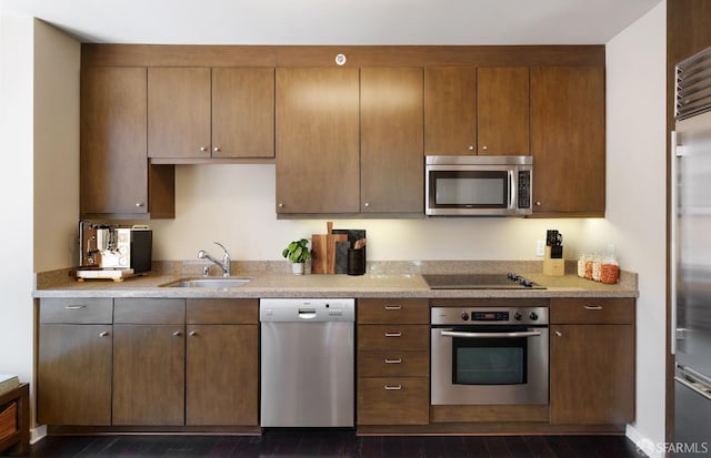 kitchen featuring sink, appliances with stainless steel finishes, and dark hardwood / wood-style flooring