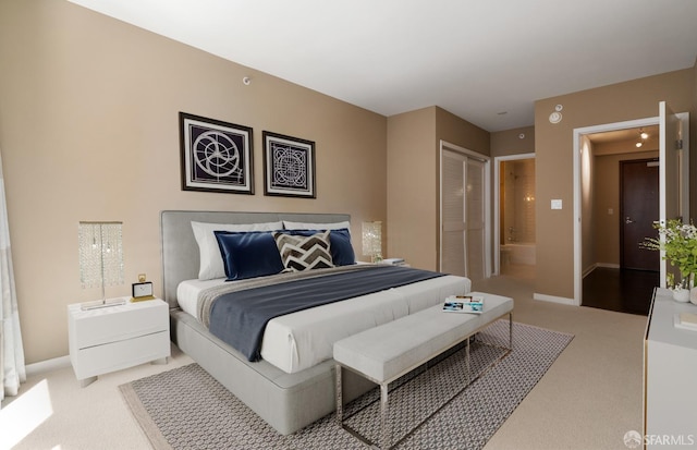 carpeted bedroom featuring a closet and ensuite bathroom