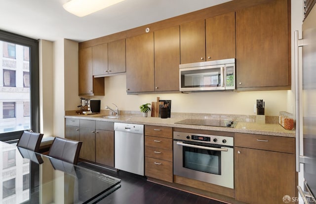 kitchen featuring stainless steel appliances, dark hardwood / wood-style floors, and sink