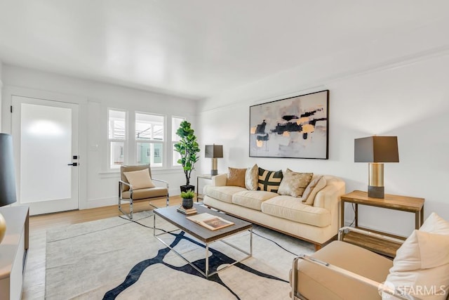 living area featuring baseboards and wood finished floors