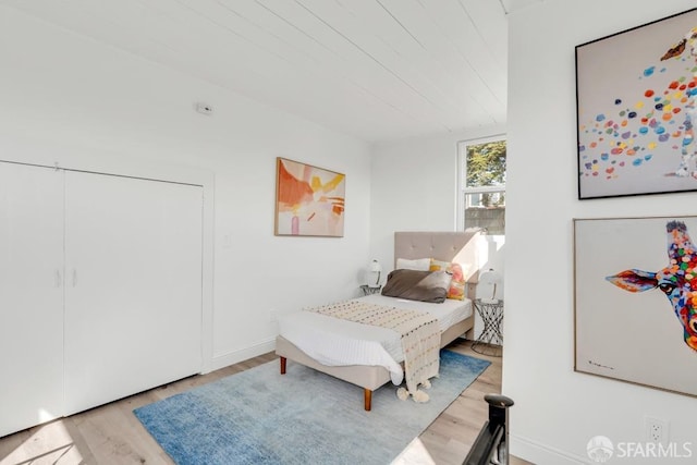 bedroom with wood finished floors and baseboards