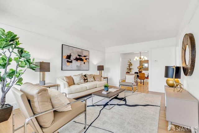 living area featuring an inviting chandelier and light wood-type flooring