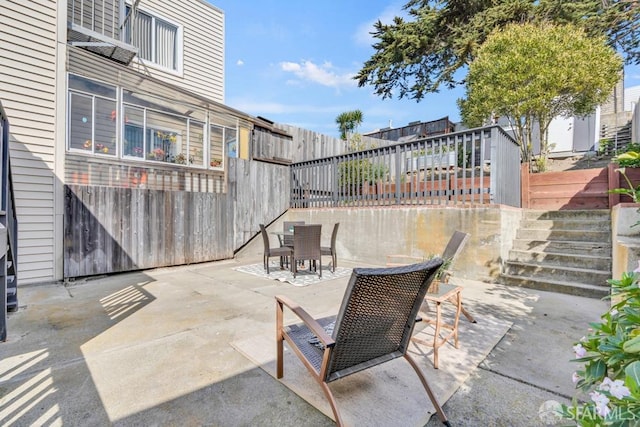 view of patio featuring outdoor dining area and a fenced backyard