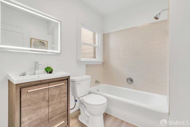 full bathroom featuring toilet, vanity, and wood finished floors