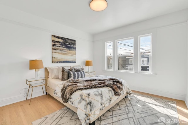 bedroom featuring wood finished floors and baseboards