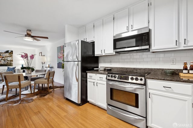 kitchen with light wood-style floors, tasteful backsplash, appliances with stainless steel finishes, and white cabinets