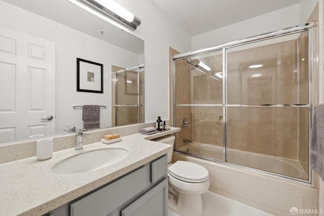 full bathroom with toilet, combined bath / shower with glass door, and vanity