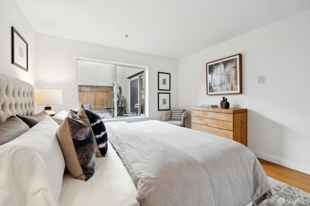 bedroom featuring wood finished floors and baseboards