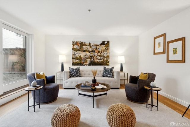 living room with baseboards and wood finished floors