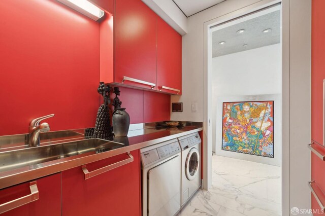 laundry area with cabinet space, separate washer and dryer, a sink, and marble finish floor